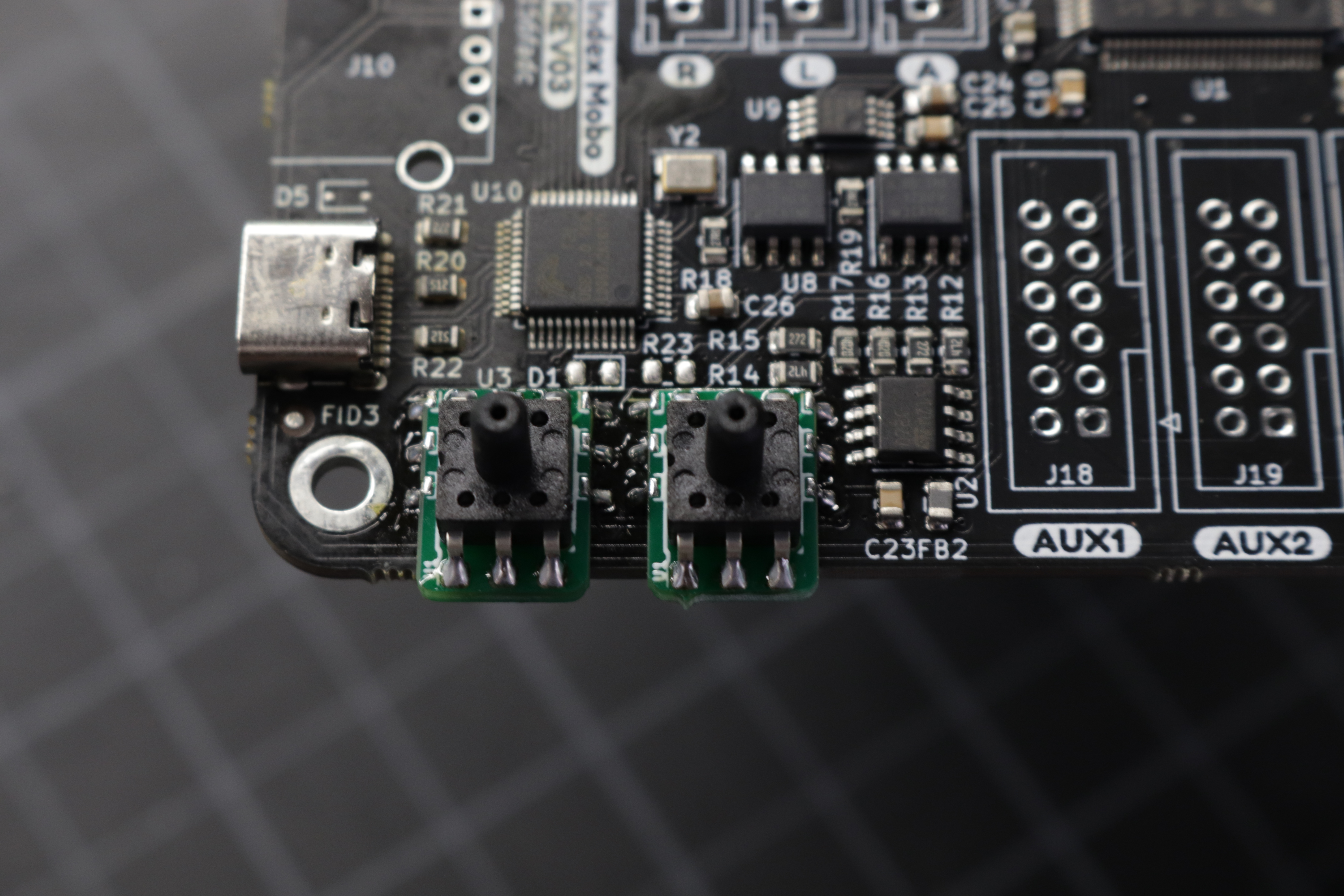 A photo showing both interposer boards soldered to the motherboard