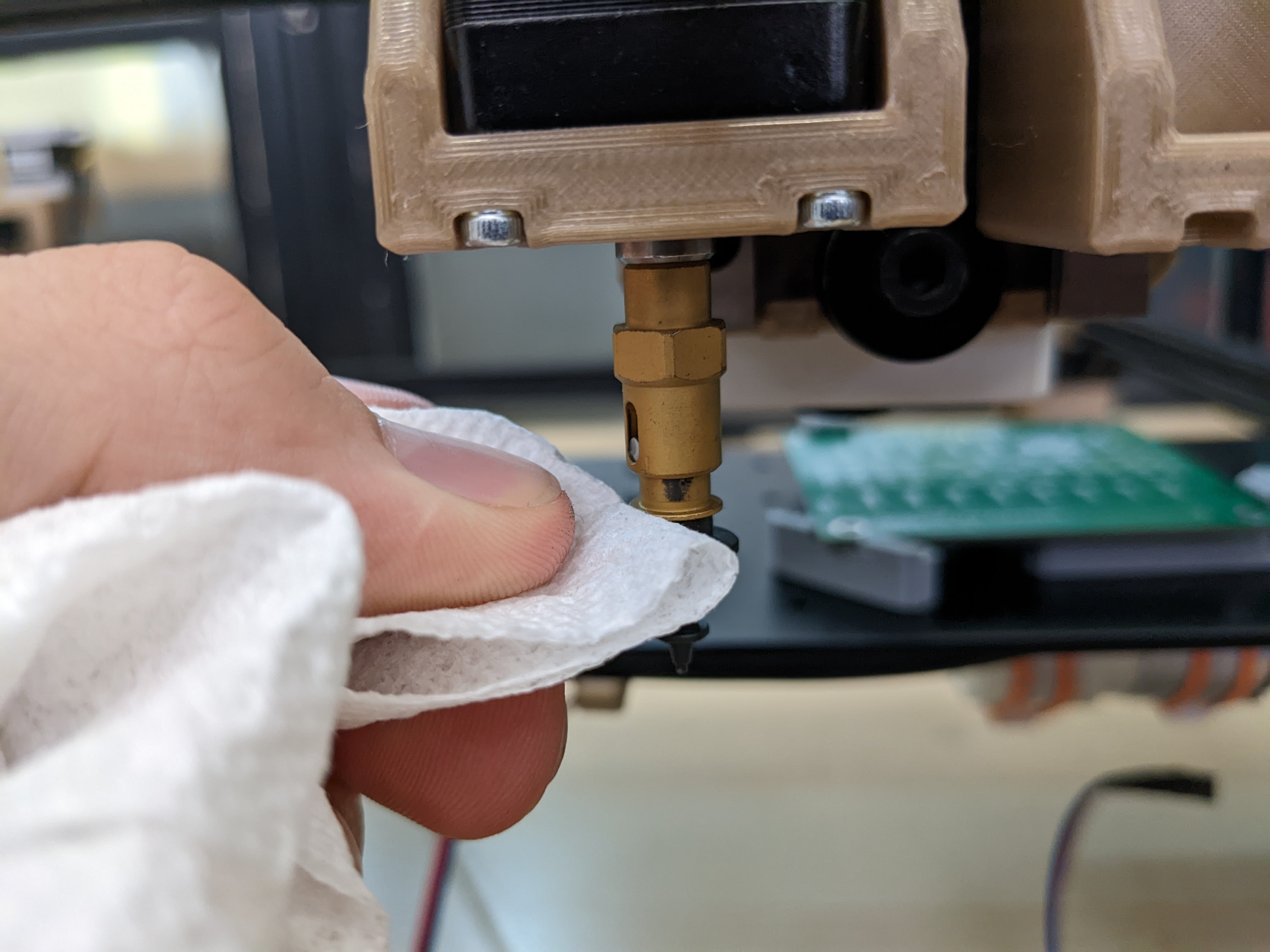 Wipe excess grease from the nozzle holder